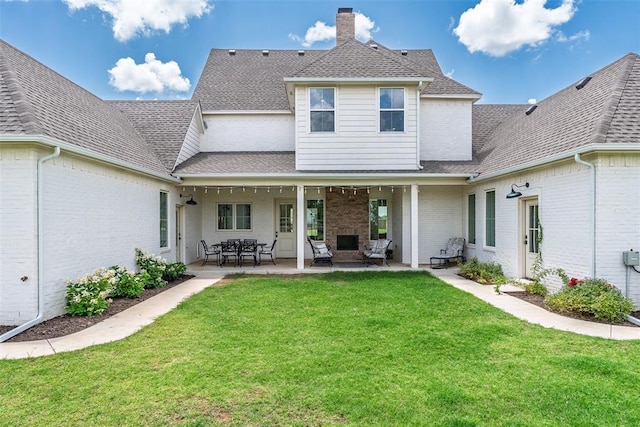 1006 Dorsi Way, Newcastle, OK 73065 - back of house featuring a shingled roof, a lawn, brick siding, and a patio area
