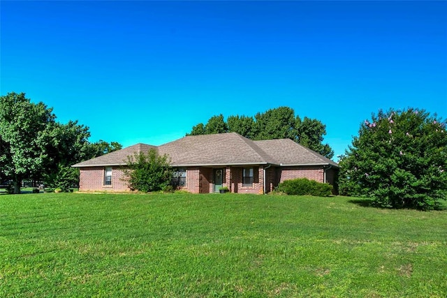 511 N Turner Rd, Chandler, OK 74834 - ranch-style house with a front yard and brick siding