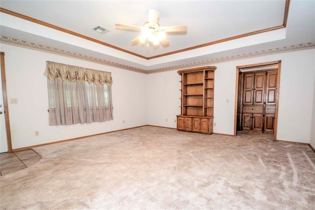 511 N Turner Rd, Chandler, OK 74834 - unfurnished room with a raised ceiling, ceiling fan, ornamental molding, and light carpet