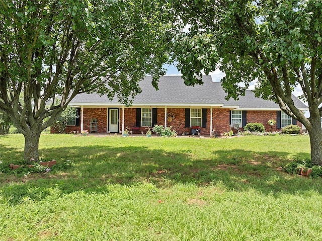 1008 County Road 1580, Marlow, OK 73055 - view of front of home featuring a shingled roof, a front yard, and brick siding