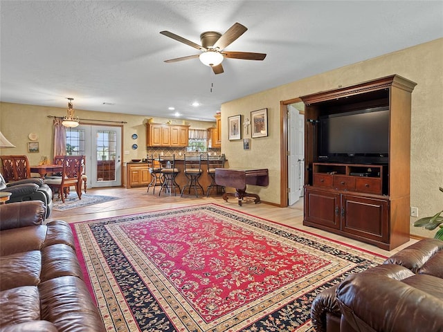 1008 County Road 1580, Marlow, OK 73055 - living area featuring ceiling fan, a textured wall, and light wood-style flooring