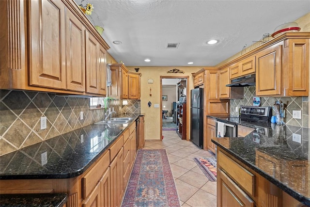1008 County Road 1580, Marlow, OK 73055 - kitchen featuring under cabinet range hood, appliances with stainless steel finishes, tasteful backsplash, light tile patterned floors, and recessed lighting