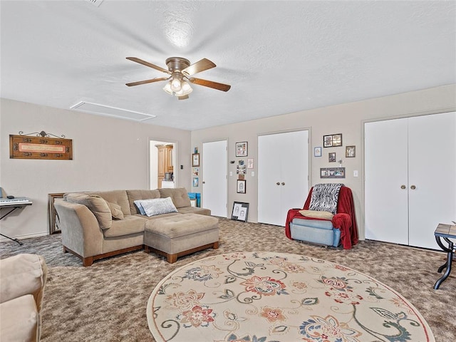 1008 County Road 1580, Marlow, OK 73055 - living room with carpet floors, a ceiling fan, attic access, and a textured ceiling