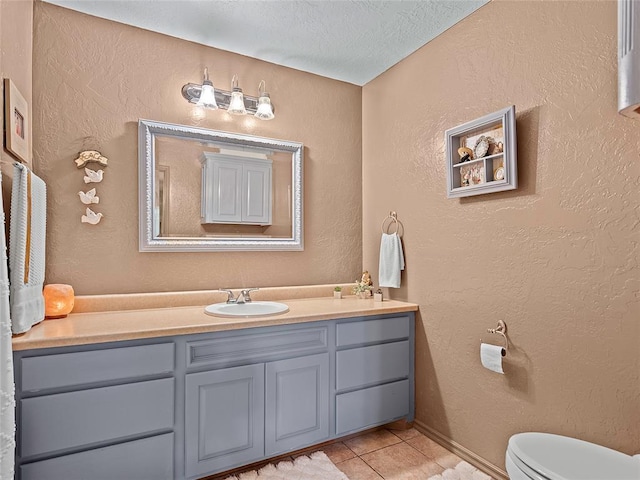 1008 County Road 1580, Marlow, OK 73055 - bathroom with tile patterned floors, vanity, a textured ceiling, and a textured wall