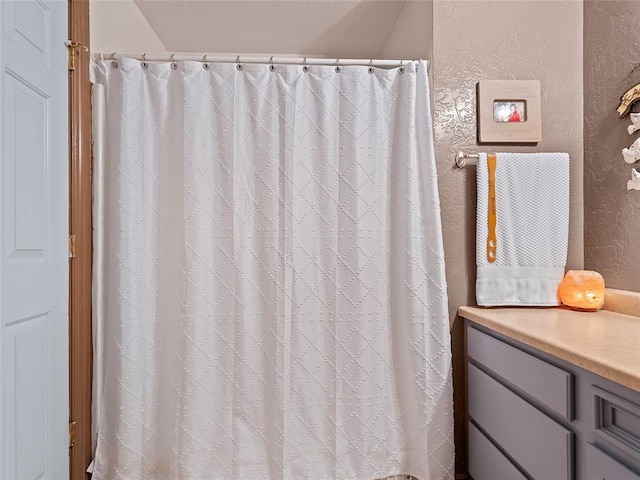 1008 County Road 1580, Marlow, OK 73055 - bathroom with a textured wall and a shower with shower curtain