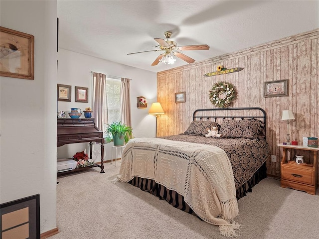 1008 County Road 1580, Marlow, OK 73055 - bedroom with carpet, wood walls, and a ceiling fan