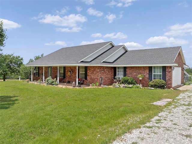 1008 County Road 1580, Marlow, OK 73055 - view of front of property with a shingled roof, a front yard, brick siding, and a porch