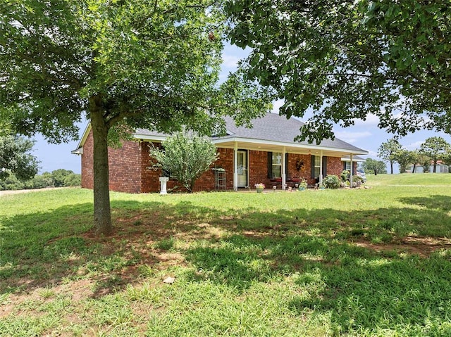 1008 County Road 1580, Marlow, OK 73055 - view of front of home with a front yard, covered porch, and brick siding