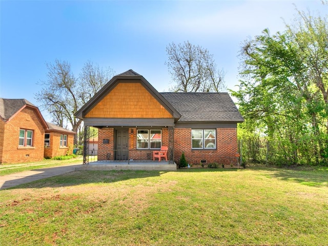 2212 N Kelham Ave, Oklahoma City, OK 73111 - view of front of home featuring a porch, brick siding, a front lawn, and a shingled roof