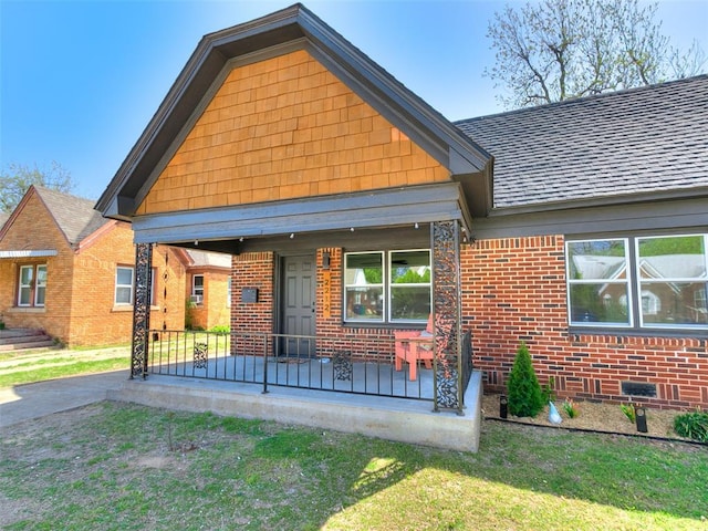 2212 N Kelham Ave, Oklahoma City, OK 73111 - view of front of house with brick siding, covered porch, and a front yard