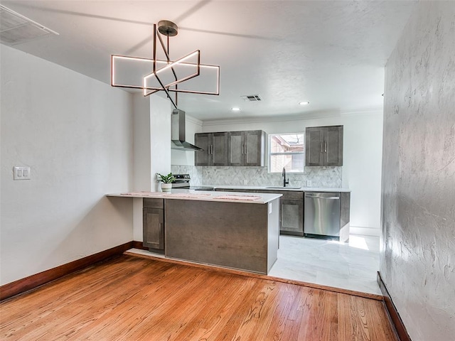2212 N Kelham Ave, Oklahoma City, OK 73111 - kitchen featuring stainless steel appliances, wall chimney range hood, light countertops, decorative backsplash, and recessed lighting