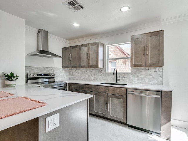2212 N Kelham Ave, Oklahoma City, OK 73111 - kitchen featuring appliances with stainless steel finishes, wall chimney exhaust hood, light countertops, dark brown cabinets, and crown molding