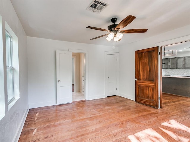 2212 N Kelham Ave, Oklahoma City, OK 73111 - unfurnished bedroom featuring light wood-type flooring, a ceiling fan, a closet, and ensuite bath