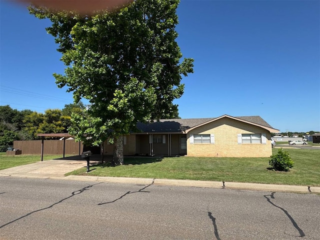 single story home featuring a carport and driveway