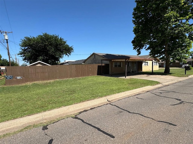 view of front of house with concrete driveway and a carport