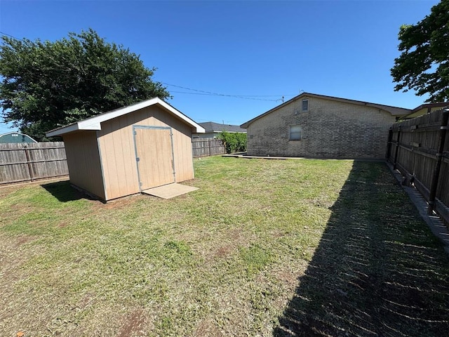 fenced backyard featuring a storage unit