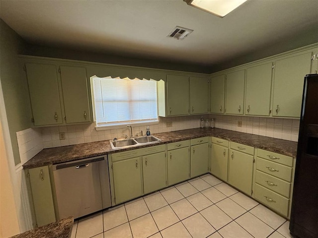 kitchen featuring dishwasher, black fridge, dark countertops, backsplash, and light tile patterned floors