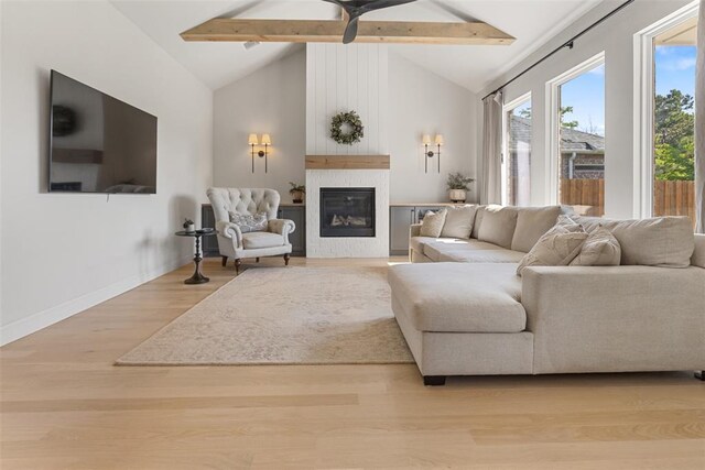 1724 Campus Corner Pl, Edmond, OK 73034 - living area featuring beamed ceiling, a large fireplace, wood finished floors, ceiling fan, and high vaulted ceiling