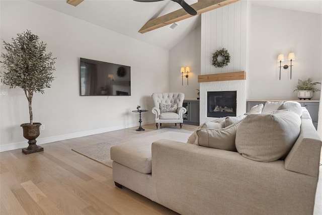 1724 Campus Corner Pl, Edmond, OK 73034 - living room with wood finished floors, beamed ceiling, ceiling fan, a large fireplace, and high vaulted ceiling