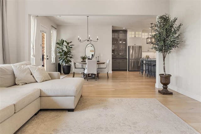 1724 Campus Corner Pl, Edmond, OK 73034 - living area with a chandelier and light wood-style floors