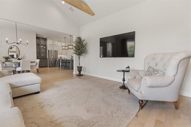 1724 Campus Corner Pl, Edmond, OK 73034 - living area featuring a chandelier, light wood-style floors, and high vaulted ceiling