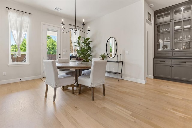 1724 Campus Corner Pl, Edmond, OK 73034 - dining room featuring a chandelier and light wood finished floors