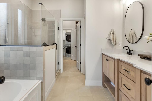 1724 Campus Corner Pl, Edmond, OK 73034 - full bath with stacked washing machine and dryer, a shower stall, vanity, tile patterned floors, and a garden tub