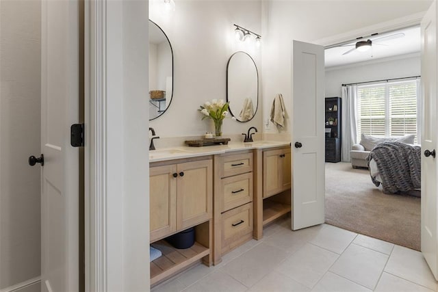 1724 Campus Corner Pl, Edmond, OK 73034 - ensuite bathroom featuring double vanity, tile patterned floors, ceiling fan, and crown molding