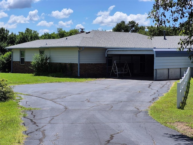 24400 Blackjack Rd, Perry, OK 73077 - view of front of property featuring driveway, brick siding, a front lawn, and an attached garage