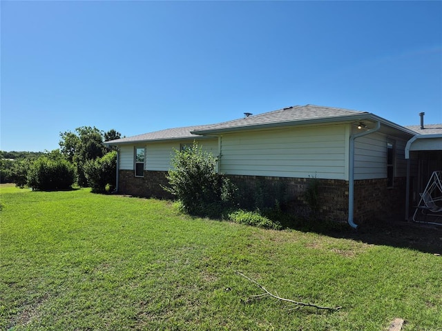 24400 Blackjack Rd, Perry, OK 73077 - view of property exterior featuring a lawn and brick siding