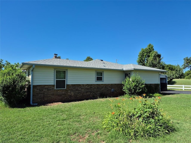 24400 Blackjack Rd, Perry, OK 73077 - view of home's exterior featuring brick siding and a chimney