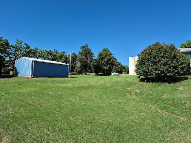 24400 Blackjack Rd, Perry, OK 73077 - view of grassy yard featuring a pole building and an outdoor structure