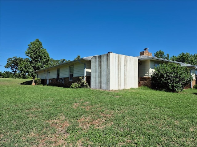 24400 Blackjack Rd, Perry, OK 73077 - view of side of home with a yard and a chimney