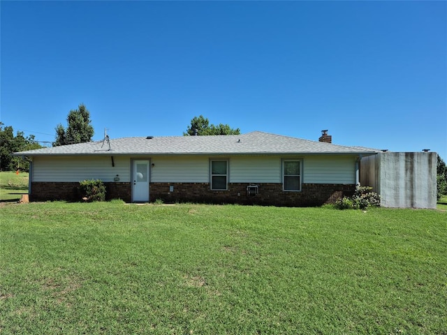 24400 Blackjack Rd, Perry, OK 73077 - view of front of property with brick siding, a front yard, and a chimney