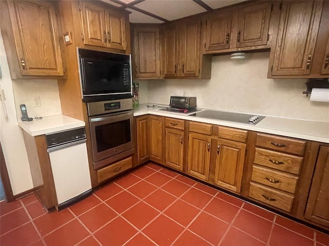 24400 Blackjack Rd, Perry, OK 73077 - kitchen featuring black appliances, light countertops, brown cabinetry, and dark tile patterned flooring