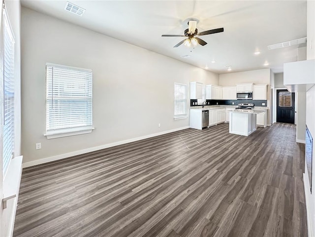 1101 N Tucker Ave, Shawnee, OK 74801 - kitchen with open floor plan, appliances with stainless steel finishes, white cabinetry, light countertops, and a ceiling fan