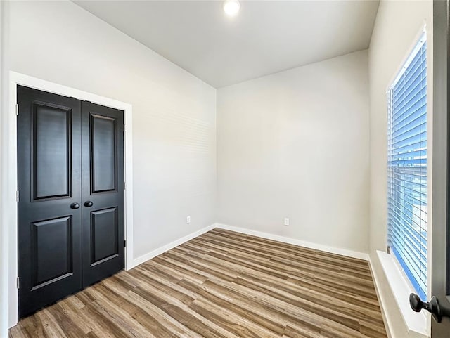 1101 N Tucker Ave, Shawnee, OK 74801 - unfurnished bedroom with wood finished floors and a closet