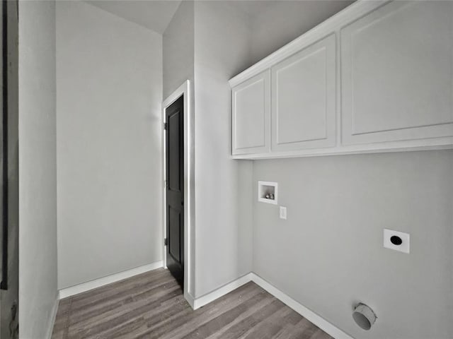 1101 N Tucker Ave, Shawnee, OK 74801 - laundry room featuring dark wood-style flooring, electric dryer hookup, washer hookup, and cabinet space