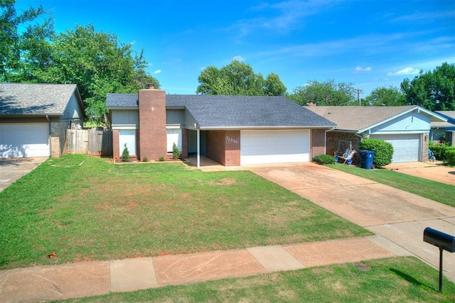 11516 N Barnes Ave, Oklahoma City, OK 73120 - view of front facade with a chimney, brick siding, a garage, driveway, and roof with shingles