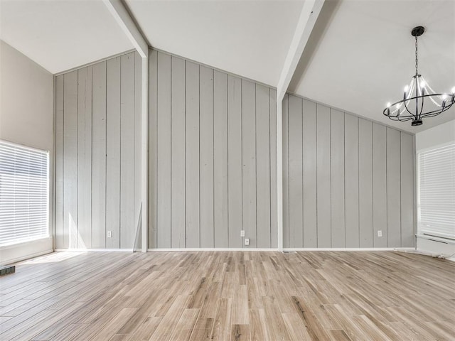 11516 N Barnes Ave, Oklahoma City, OK 73120 - unfurnished living room with a chandelier, wooden walls, and light wood finished floors