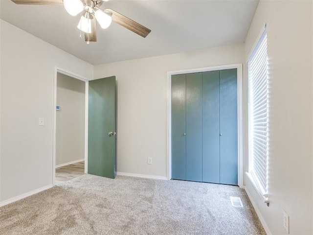 11516 N Barnes Ave, Oklahoma City, OK 73120 - unfurnished bedroom featuring carpet, multiple windows, a closet, and a ceiling fan