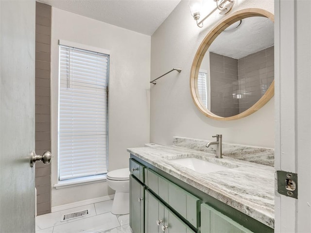 11516 N Barnes Ave, Oklahoma City, OK 73120 - bathroom featuring vanity, a textured ceiling, and marble finish flooring