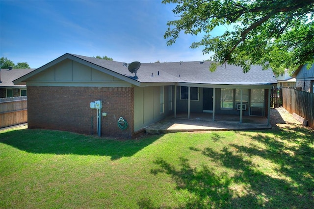 11516 N Barnes Ave, Oklahoma City, OK 73120 - rear view of property featuring board and batten siding, a fenced backyard, a patio, brick siding, and roof with shingles