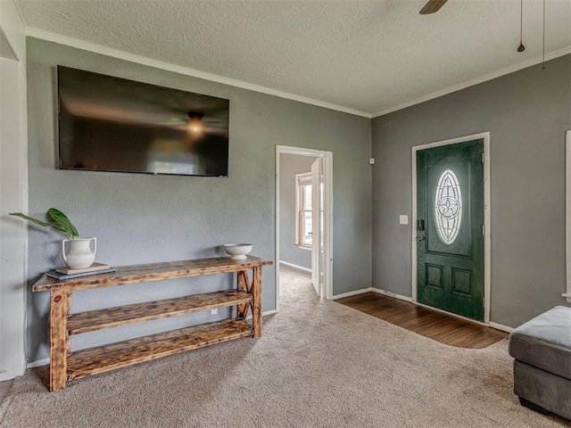 901 S 11th St, Kingfisher, OK 73750 - foyer with a textured ceiling, carpet flooring, ornamental molding, and a ceiling fan
