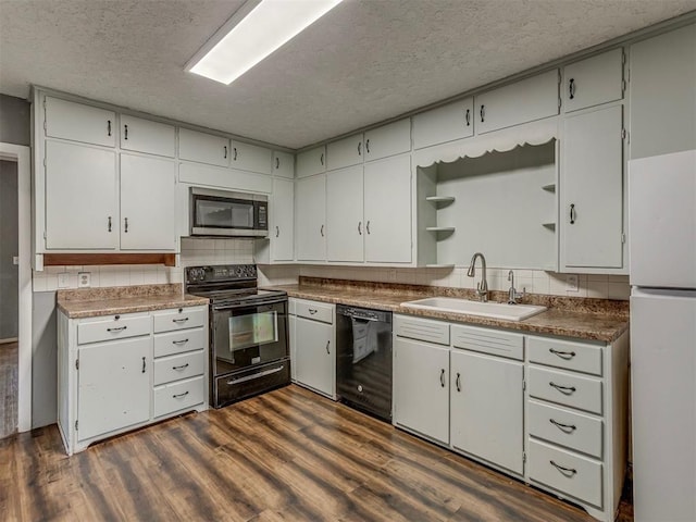 901 S 11th St, Kingfisher, OK 73750 - kitchen with black appliances, open shelves, dark wood-style floors, a textured ceiling, and backsplash