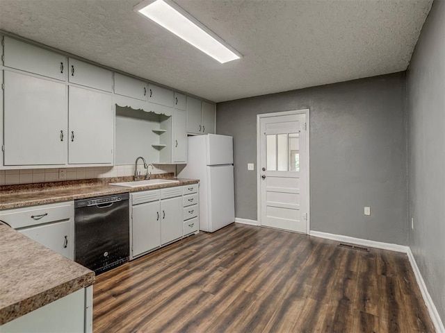 901 S 11th St, Kingfisher, OK 73750 - kitchen featuring dishwasher, freestanding refrigerator, dark wood-style flooring, a textured ceiling, and white cabinets