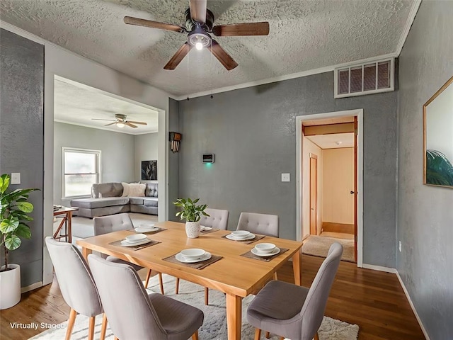 901 S 11th St, Kingfisher, OK 73750 - dining space featuring wood finished floors, a textured ceiling, ceiling fan, and a textured wall