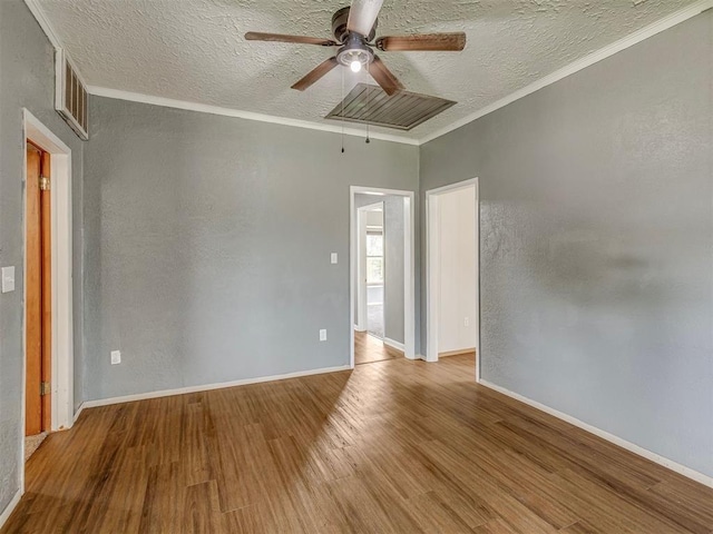 901 S 11th St, Kingfisher, OK 73750 - unfurnished room with ceiling fan, wood finished floors, a textured ceiling, and crown molding