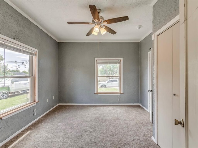 901 S 11th St, Kingfisher, OK 73750 - spare room featuring carpet, ceiling fan, a textured wall, crown molding, and a smoke detector