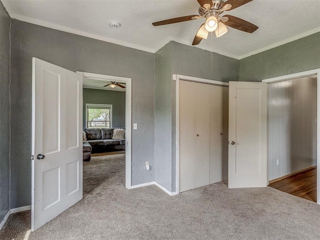 901 S 11th St, Kingfisher, OK 73750 - unfurnished bedroom with a textured wall, carpet floors, crown molding, a ceiling fan, and a closet